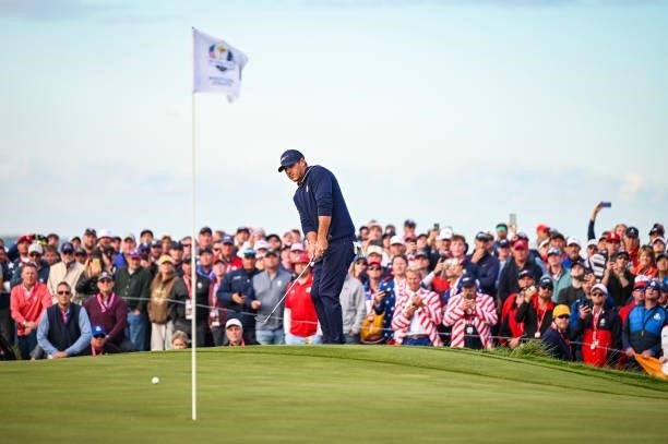Brooks Koepka of the U.S. Team chips a shot to the 15th hole green as fans watch during Saturday Afternoon Four-ball Matches of the 43rd Ryder Cup at...