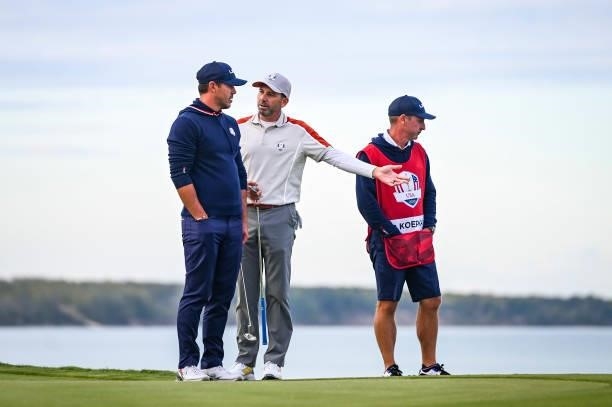Sergio Garcia of Spain and Team Europe speaks to Brooks Koepka of the U.S. Team about a ruling on the 16th hole green during Saturday Afternoon...
