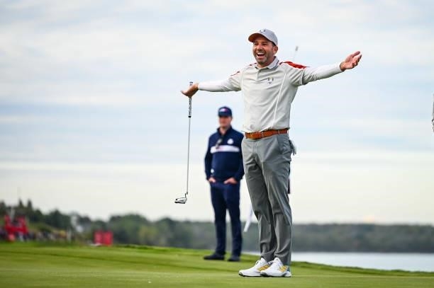 Sergio Garcia of Spain and Team Europe celebrates with arms open after teammate Jon Rahm made an eagle putt on the 16th hole green during Saturday...