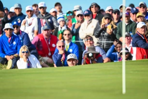 Tyrrell Hatton of England and Team Europe chips a shot to the 15th hole green as fans watch during Saturday Afternoon Four-ball Matches of the 43rd...