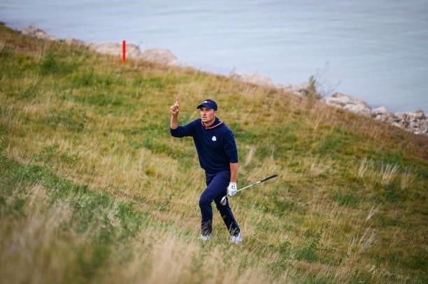 Jordan Spieth of the U.S. Team asks where his ball landed after playing a shot from along the shore of Lake Michigan up a hill towards the 16th hole...