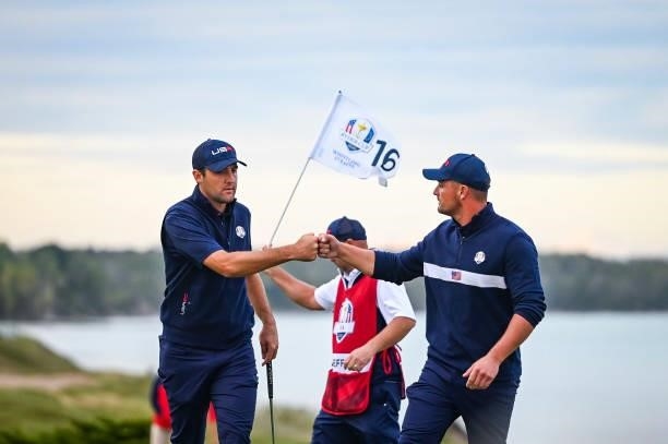 Scottie Scheffler and Bryson DeChambeau of the U.S. Team celebrate on the 16th hole green during Saturday Afternoon Four-ball Matches of the 43rd...