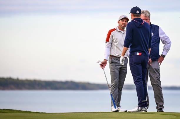 Sergio Garcia of Spain and Team Europe and Jordan Spieth of the U.S. Team speak to a Rules Official on the 16th hole green during Saturday Afternoon...