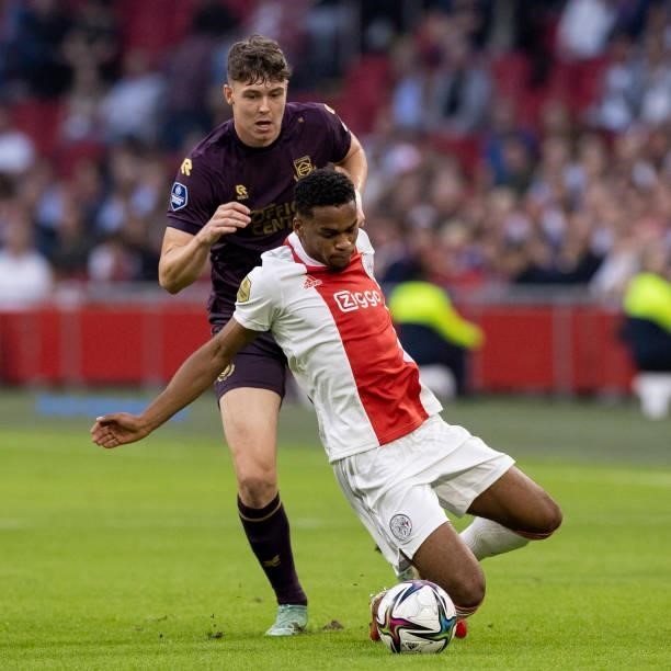 Jurrien Timber of AFC Ajax and Jorgen Strand Larsen of FC Groningen Battle for the ball during the Dutch Eredivisie match between Ajax and FC...