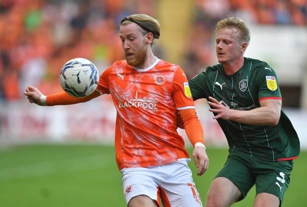 Blackpool's Josh Bowler battles with Barnsley's Ben Williams during the Sky Bet Championship match between Blackpool and Barnsley at Bloomfield Road...