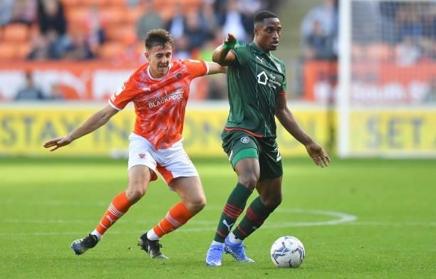 Blackpool's Ryan Wintle battles with Barnsley's Victor Adeboyejo during the Sky Bet Championship match between Blackpool and Barnsley at Bloomfield...