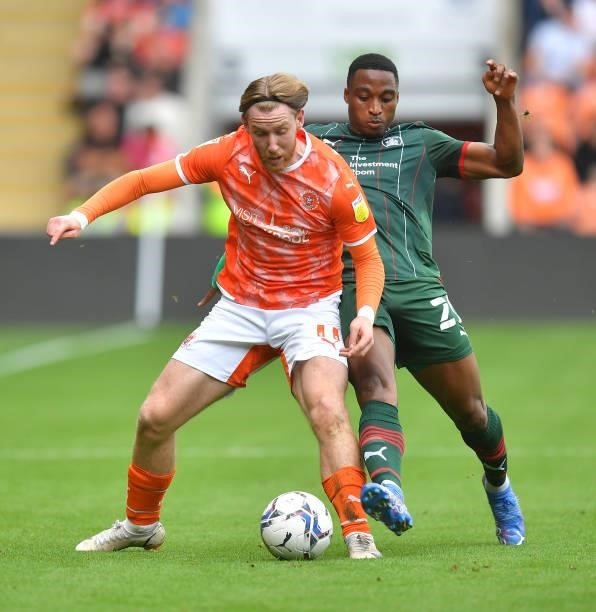 Blackpool's Josh Bowler battles with Barnsley's Toby Sibbick during the Sky Bet Championship match between Blackpool and Barnsley at Bloomfield Road...