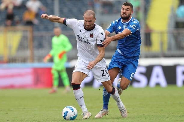 Lorenzo De Silvestri of Bologna FC in action against Patrick Cutrone of Empoli FC during the Serie A match between Empoli FC and Bologna FC at Stadio...