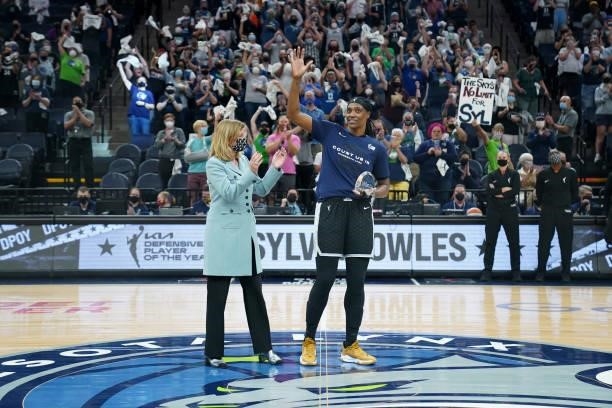 Commissioner Cathy Engelbert presents Sylvia Fowles of the Minnesota Lynx with the WNBA Kia Defensive Player of the Year trophy before the game...