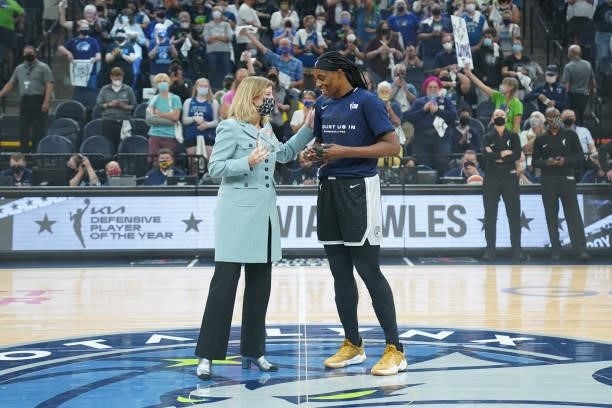 Commissioner Cathy Engelbert presents Sylvia Fowles of the Minnesota Lynx with the WNBA Kia Defensive Player of the Year trophy before the game...