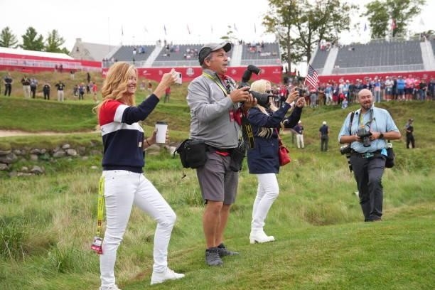 Tabatha Furyk and Montan Pritchard take photos after the United States victory in the 2020 Ryder Cup at Whistling Straits on September 26, 2021 in...