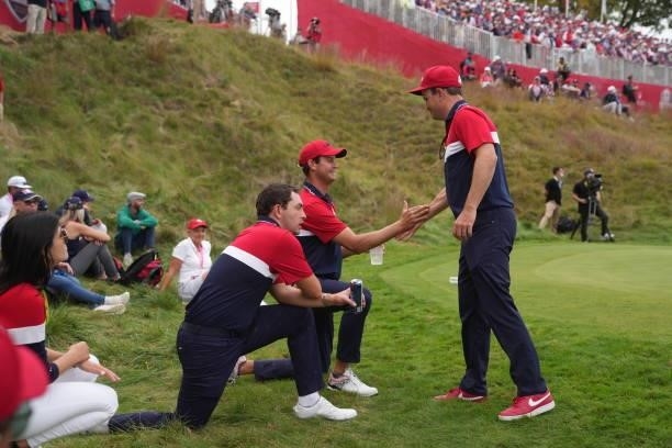 United States Vice-Captain Zach Johnson, R-L, Harris English of Team United States and Patrick Cantlay of Team United States celebrate after the...