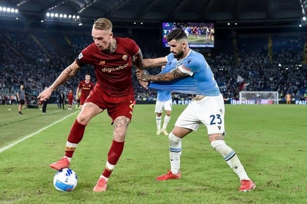 Rick Karsdorp of AS Roma and Elseid Hysaj of SS Lazio compete for the ball during the Serie A match between SS Lazio and AS Roma at Stadio Olimpico,...
