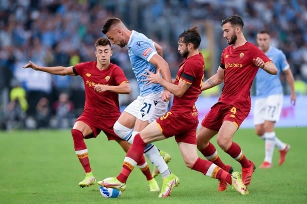 Sergej Milinkovic-Savic of SS Lazio is challenged by Stephan El Shaarawy of AS Roma, Bryan Cristante of AS Roma and Matias Vina of AS Roma during the...