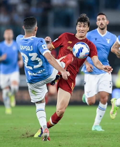 Eldor Shomurodov of AS Roma and Elseid Hysaj of SS Lazio compete for the ball during the Serie A match between SS Lazio and AS Roma at Stadio...