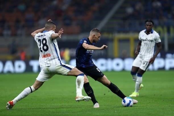 Edin Dzeko of FC Internazionale and Merih Demiral of Atalanta BC battle for the ball during the Serie A match between FC Internazionale and Atalanta...