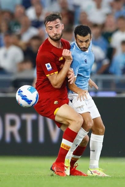 Bryan Cristante of AS Roma and Pedro of SS Lazio battle for the ball during the Serie A match between SS Lazio and AS Roma at Stadio Olimpico on...