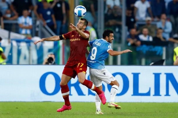 Henrikh Mkhitaryan of AS Roma and Pedro of SS Lazio battle for the ball during the Serie A match between SS Lazio and AS Roma at Stadio Olimpico on...