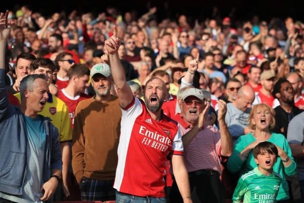 Arsenal fans sing during the Premier League match between Arsenal and Tottenham Hotspur at Emirates Stadium on September 26, 2021 in London, England.