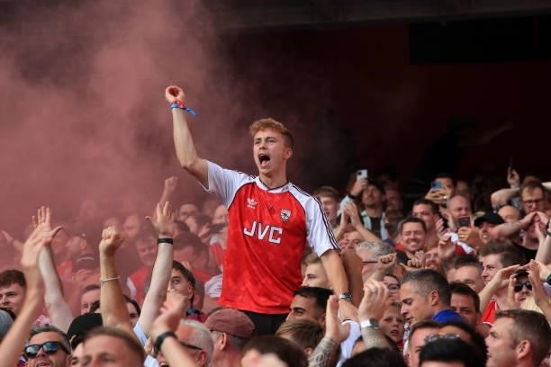 Arsenal fans celebrate the first goal during the Premier League match between Arsenal and Tottenham Hotspur at Emirates Stadium on September 26, 2021...