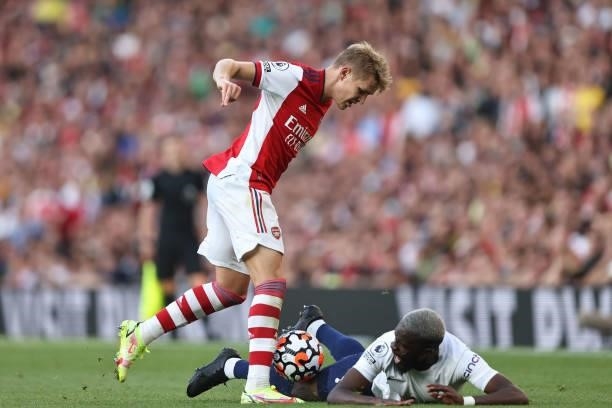 Tanguy Ndombele of Tottenham Hotspur in action with Martin Odegaard of Arsenal during the Premier League match between Arsenal and Tottenham Hotspur...