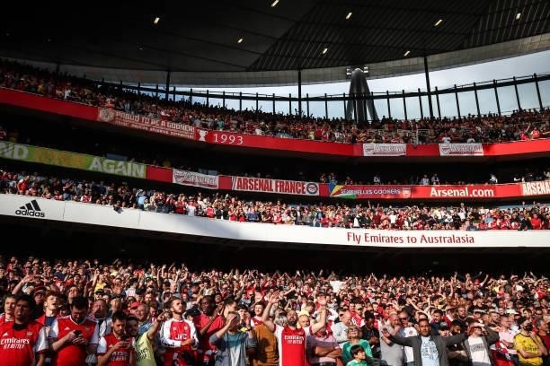 Arsenal fans sing during the Premier League match between Arsenal and Tottenham Hotspur at Emirates Stadium on September 26, 2021 in London, England.