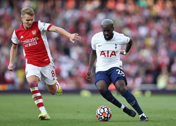 Tanguy Ndombele of Tottenham Hotspur in action with Martin Odegaard of Arsenal during the Premier League match between Arsenal and Tottenham Hotspur...