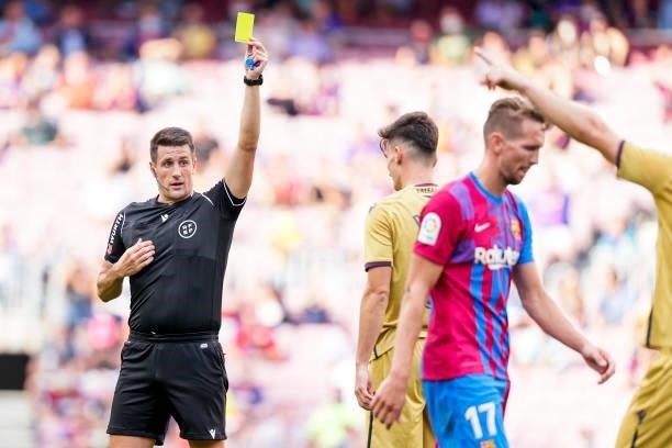 Referee Isidro Diaz de Mera Escuderos show the yellow card to Jose Luis Garcia Pepelu of Levante during the La Liga Santander match between FC...