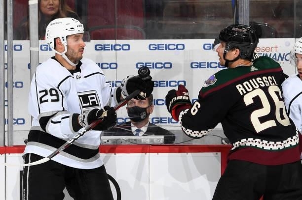 Antoine Roussel of the Arizona Coyotes and Martin Frk of the Los Angeles Kings battle for a loose puck at Gila River Arena on September 27, 2021 in...
