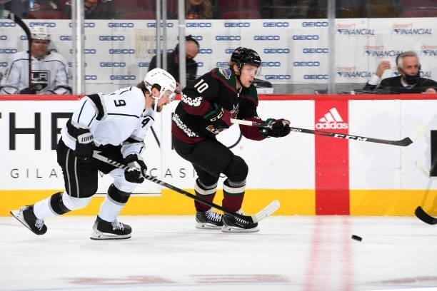 Ryan Dzingel of the Arizona Coyotes passes the past Adrian Kempe of the Los Angeles Kings at Gila River Arena on September 27, 2021 in Glendale,...
