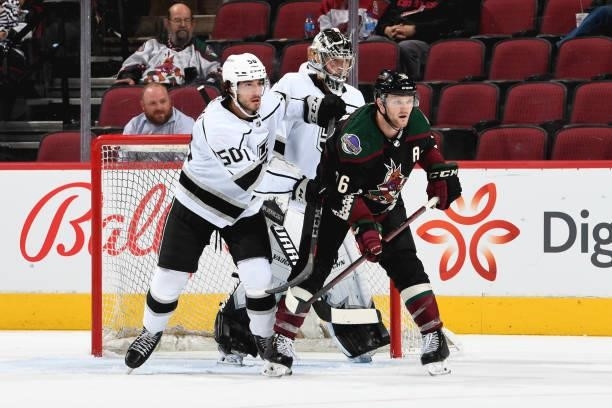 Christian Fischer of the Arizona Coyotes battles for position with Sean Durzi of the Los Angeles Kings at Gila River Arena on September 27, 2021 in...