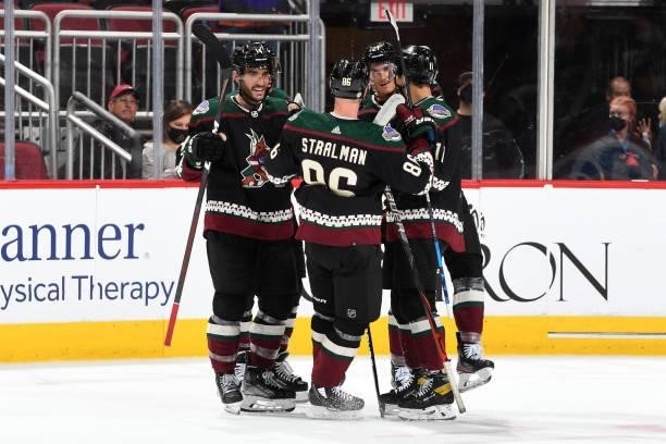 Dylan Guenther of the Arizona Coyotes celebrates with Shaye Gostibehere, Anton Stralman and Loui Eriksson after scoring a goal against the Los...