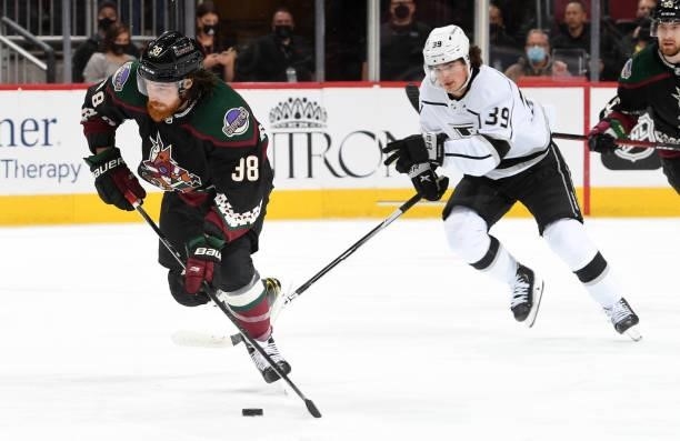 Liam O'Brien of the Arizona Coyotes skates the puck up ice while being chased by Alex Turcotte of the Los Angeles Kings at Gila River Arena on...