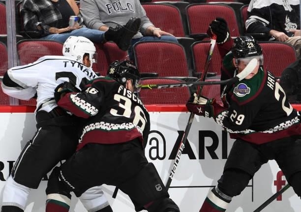 Barrett Hayden of the Arizona Coyotes gets high sticked by TJ Tynan of the Los Angeles Kings at Gila River Arena on September 27, 2021 in Glendale,...