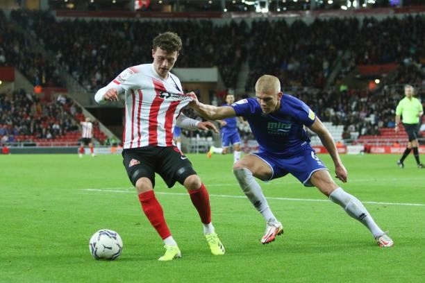 Nathan Broadhead of Sunderland and Lewis Freestone of Cheltenham Town in action during the Sky Bet League 1 match between Sunderland and Cheltenham...