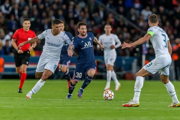 Rodri of Manchester City, Lionel Messi of Paris Saint-Germain and Ruben Dias of Manchester City battle for the ball during the UEFA Champions League...