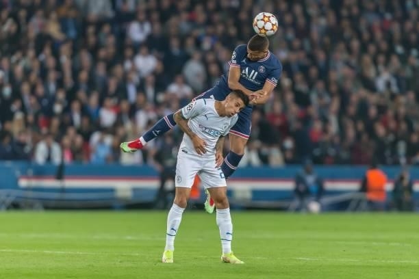 Riyad Mahrez of Manchester City and Kylian Mbappe of Paris Saint-Germain battle for the ball during the UEFA Champions League match between Paris...