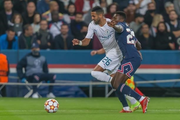 Riyad Mahrez of Manchester City and INuno Mendes of Paris Saint-Germain battle for the ball during the UEFA Champions League match between Paris...