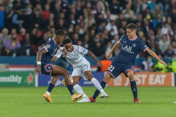 Presnel Kimpembe of Paris Saint-Germain, Raheem Sterling of Manchester City and Andre Herrera of Paris Saint-Germain battle for the ball during the...