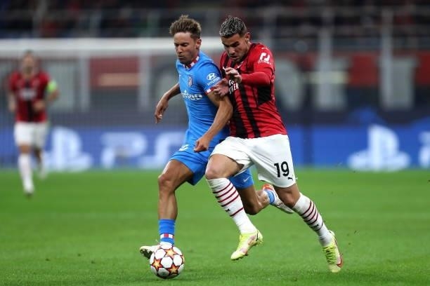 Theo Hernandez of AC Milan and Marcos Llorente of Atletico Madrid battle for the ball during the UEFA Champions League Group B match between AC Milan...