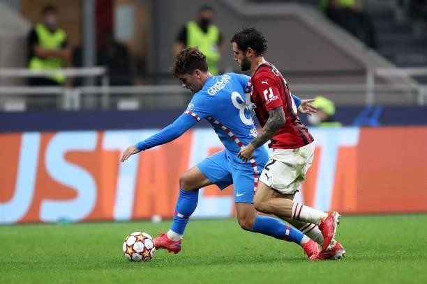 Antoine Griezmann of Atletico Madrid and Davide Calabria of AC Milan battle for the ball during the UEFA Champions League Group B match between AC...