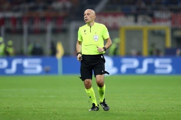 Referee Cuneyt Cakir looks on during the UEFA Champions League Group B match between AC Milan and Atletico Madrid at Giuseppe Meazza Stadium on...