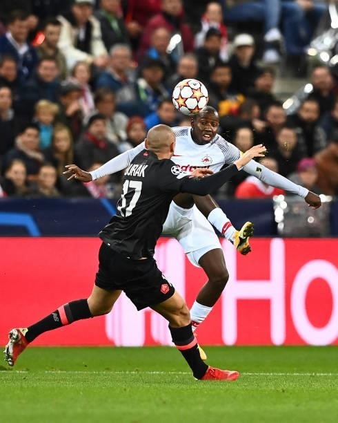 Lille's Turkish forward Burak Yilmaz and Salzburg's Malian midfielder Mohamed Camara vie for the ball the UEFA Champions League Group G football...