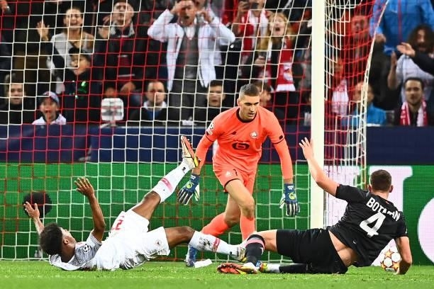 Salzburg's German forward Karim Adeyemi is brought down by Lille's Dutch defender Sven Botman giving away a penalty during the UEFA Champions League...