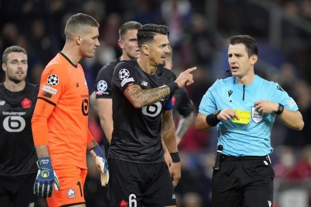 Jose Fonte of Lille, Ivo Grbic of Lille and Referee Halil Umut Meler of Turkey during the UEFA Champions League group G match between FC Red Bull...