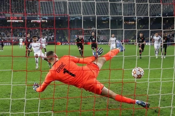 Salzburg's German forward Karim Adeyemi scores his second penalty past Lille's Croatian goalkeeper Ivo Grbic during the UEFA Champions League Group G...