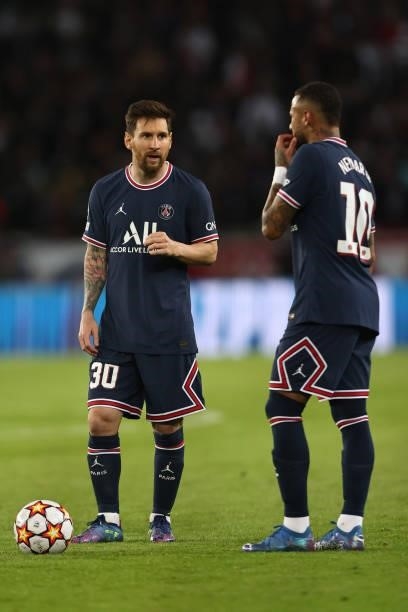 Lionel Messi and Neymar of Paris Saint-Germain stand over a free kick during the UEFA Champions League group A match between Paris Saint-Germain and...