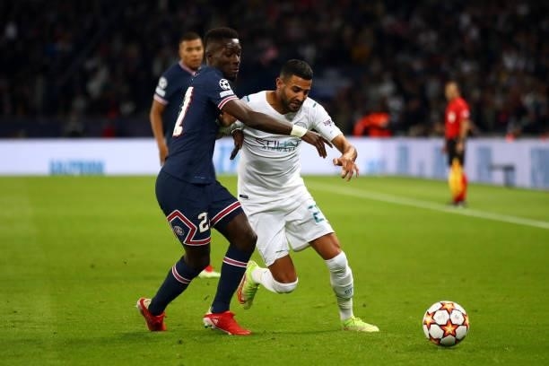 Idrissa Gueye of Paris Saint-Germain tangles with Riyad Mahrez of Manchester City during the UEFA Champions League group A match between Paris...