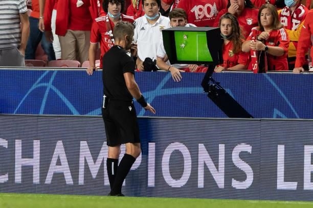 Referee Daniele Orsato looks at VAR during the UEFA Champions League group E match between SL Benfica and FC Barcelona at Estadio da Luz on September...