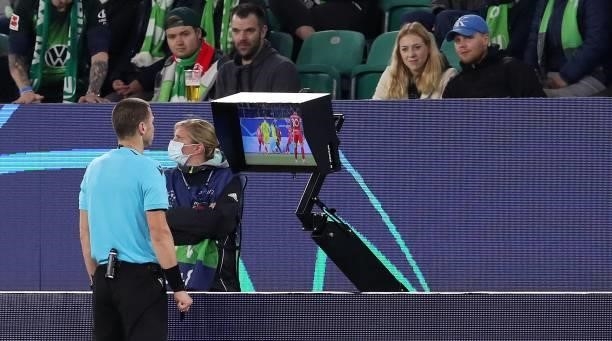 Bulgarian referee Georgi Kabakov checks the VAR before awarding a penalty during the UEFA Champions League Group G football match between VfL...